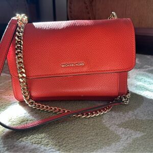 Michael Kors Claire Crossbody Bag with Gold Chain in Vibrant Burnt Sienna.